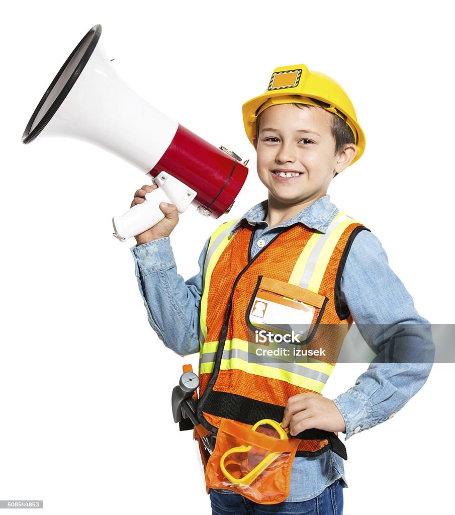 Junior Construction Worker Portrait of little boy dressed as contruction worker, holding a megaphone in hand and similing at the camera. Studio shot, isolated on white. Child Stock Photo