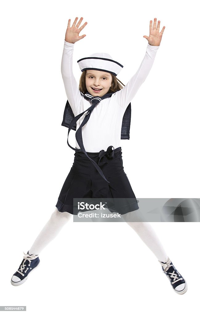 Sailor Girl Full lenght portrait of jumping little girl dressed as a sailor. Studio shot, isolated on white. Child Stock Photo