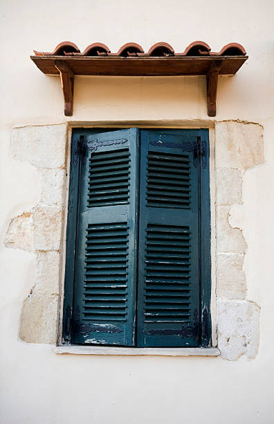 istock Black shutters on a beige concrete building. 508544945