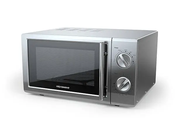 Photo of Metallic microwave oven isolated on white background.