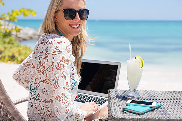 istock Successful business woman working with computer on the beach 508545610