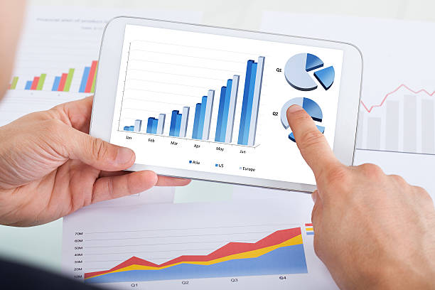 istock Businessman Comparing Graphs On Digital Tablet At Office Desk 508546783