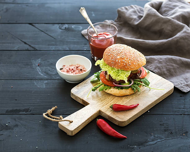 istock Fresh homemade burger on dark serving board with spicy tomato 508548004