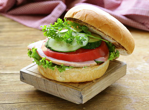 istock snack burger with fresh vegetables and ham on wooden board 508548383