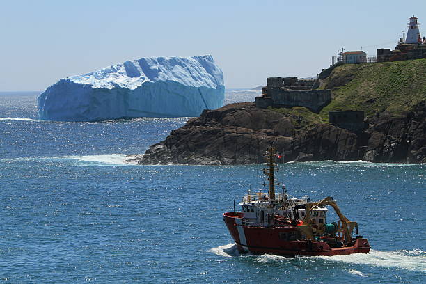 Iceberg at Fort Amherst, St John's A huge iceberg floats in the harbor of St.John's , Newfoundland, Canada. June 13, 2014 newfoundland & labrador stock pictures, royalty-free photos & images