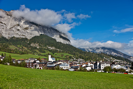 Skyline of Vaduz, principality of Liechtenstein. Scenic aerial view of city in Swiss Alps. Panorama of green valley with town and blue sky in summer. Landscape of Liechtenstein in Alpine mountains.
