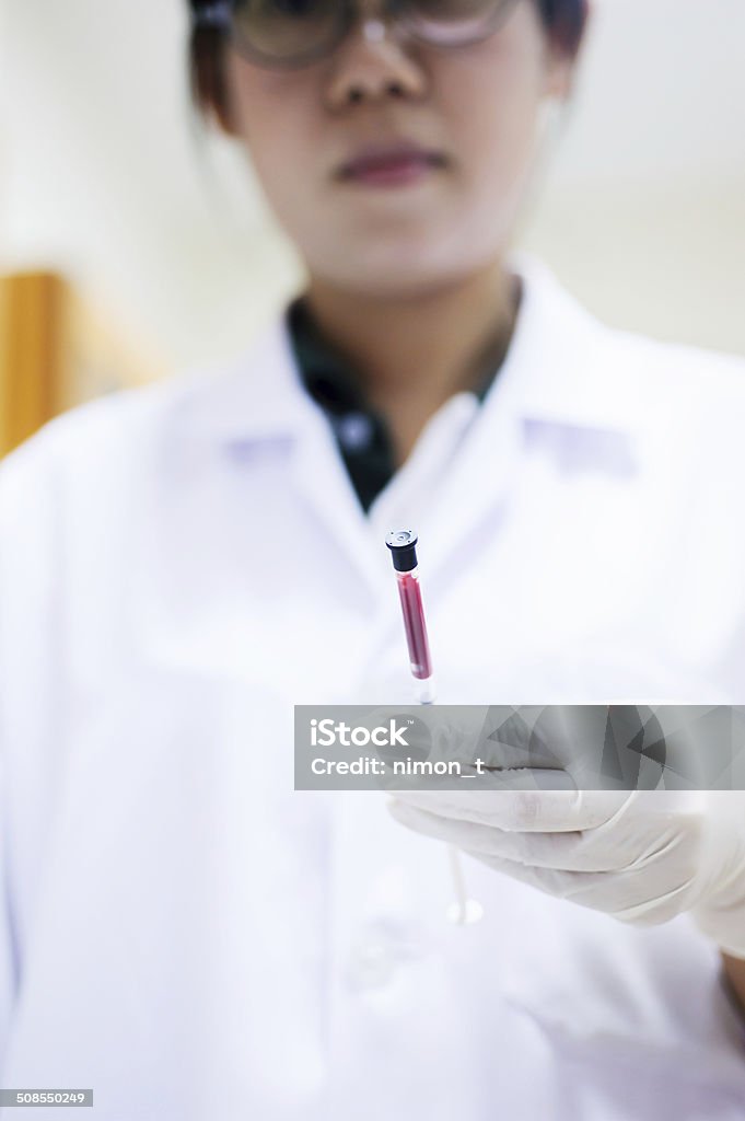Scientist working at laboratory Scientist working at the blood laboratory Analyzing Stock Photo