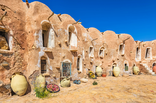 The Ksar Ouled Debbab is a village of about 1,000 inhabitants in the delegation Tataouine South in Tataouine Governorate in southern Tunisia. In the old town is one of the most impressive castles storage (ksour) of the country. Quarrystones and clay built Ksar consisting superposed from a closed courtyard with two floors and vaulted storage chambers (ghorfas). The chambers were used as storerooms for stocks (cereals, oil, dried beans, lentils, dates, etc.) and other belongings kind (household and work tools, weapons) for the semi-nomadic (transhumance) families living situation.