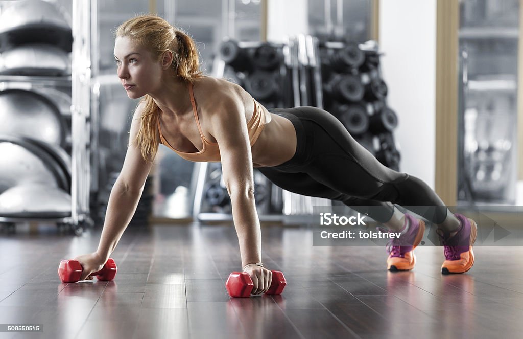 Workout in the gym Woman push-ups on the floor Active Lifestyle Stock Photo