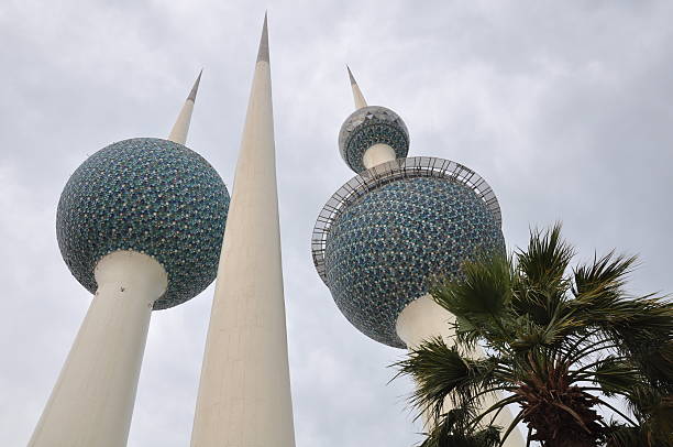 View of the illuminated Kuwait Towers at night.
