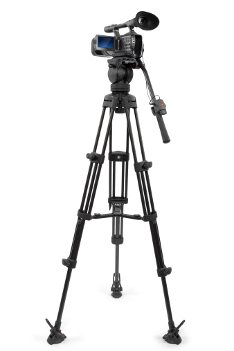 production camera on a tripod and isolated on white background