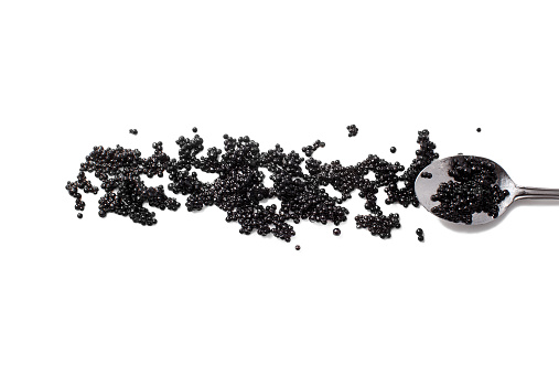 Negro caviar de y cuchara aislado sobre fondo blanco photo