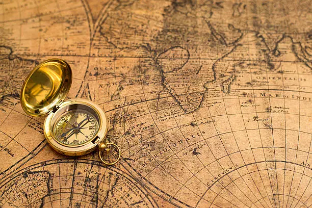 Photo of old compass  on vintage map