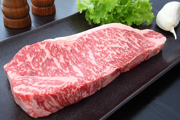 Kobe beef Kobe beef with garlic,salt and pepper wagyu beef stock pictures, royalty-free photos & images