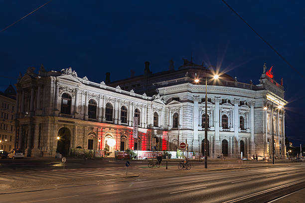 Burgtheater in Vienna Vienna, Austria - July 28, 2015: The outside of the Burgtheater in Vienna at night. A person can be seen. burgtheater vienna stock pictures, royalty-free photos & images