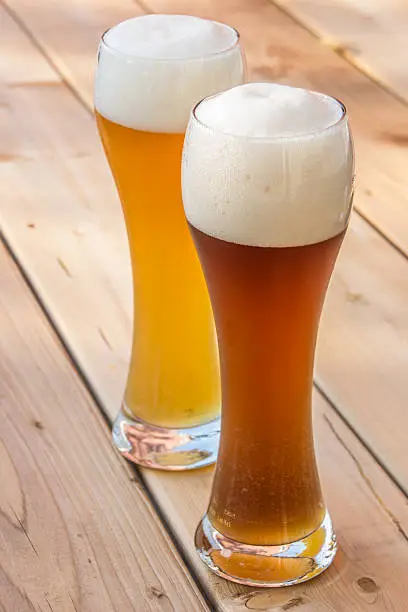 Light and dark German wheat beer in a traditional glass
