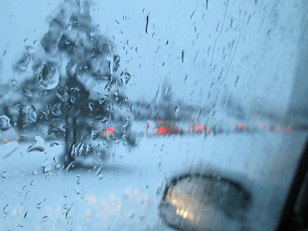 istock Snow on road from car at night 508580824