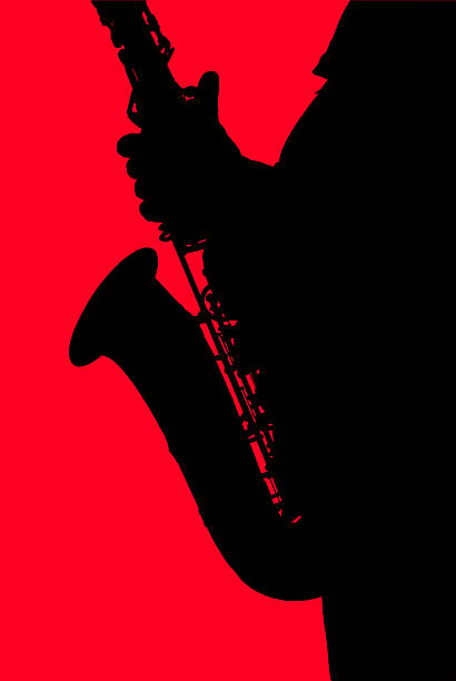 istock Black silhouette of the saxophone on a red background. 508581271