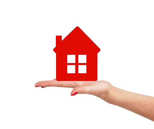 istock Female hand with small model of house isolated 508582548