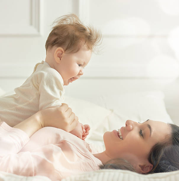 istock mother playing with her baby 508583478
