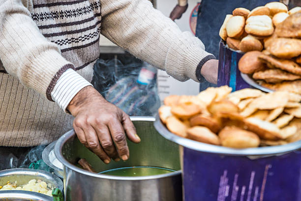 Indian street food A Indian man cooking on a Delhi street. panipuri stock pictures, royalty-free photos & images