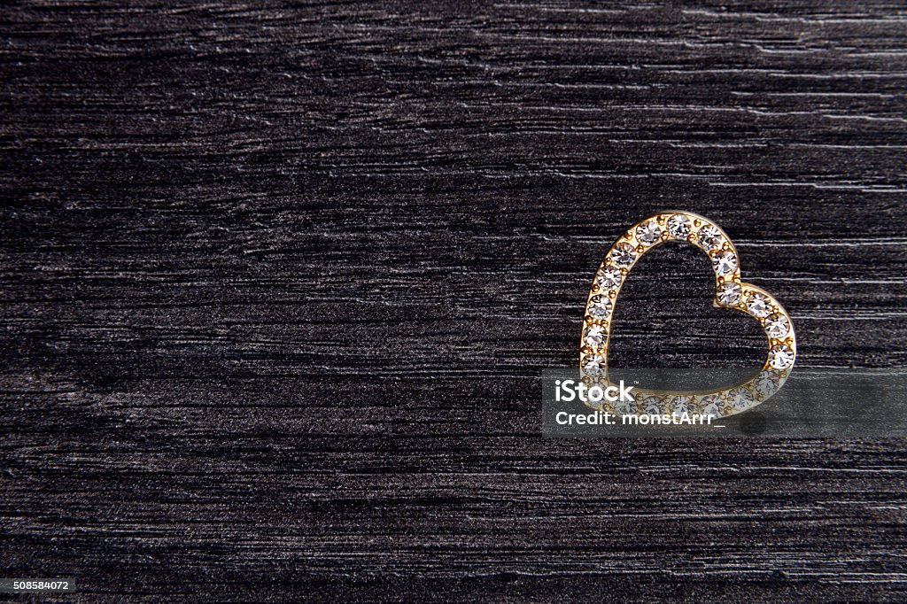 Jewelry brooch in shape of heart for valentines day Gold jewelry brooch in shape of heart on wooden background for valentines day as valentines card or background Arts Culture and Entertainment Stock Photo