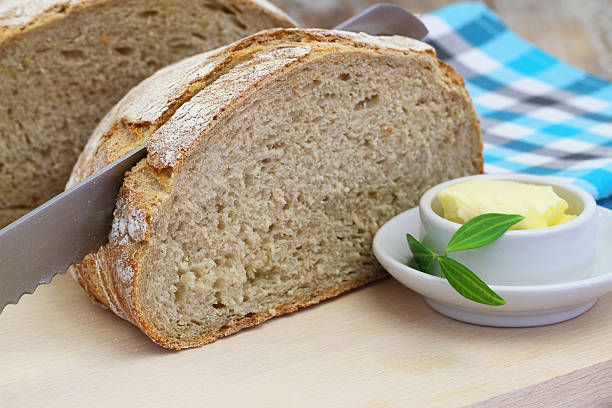 istock Brown bread on wooden board and butter 508584160