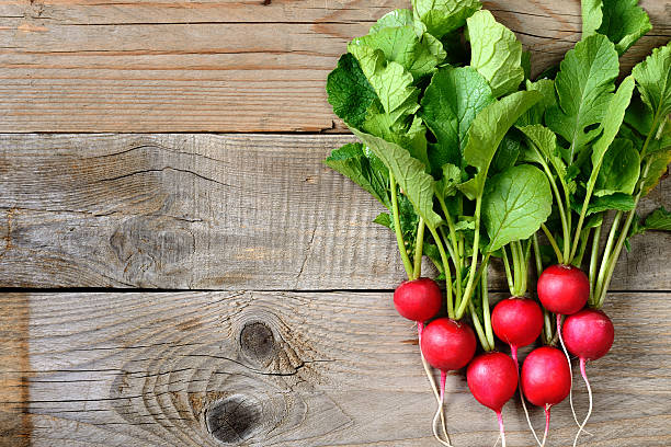 Fresh radishes on wooden table