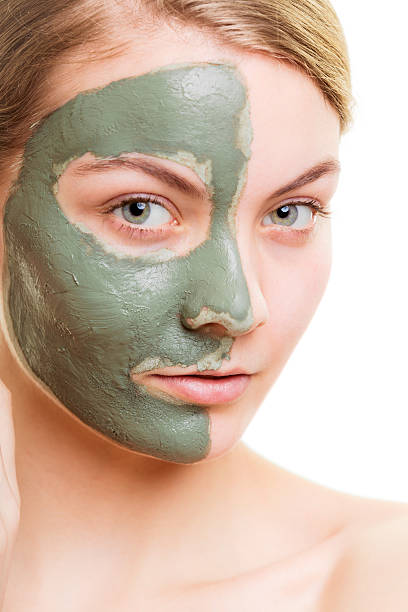 istock Woman in clay mud mask on face isolated on white. 508586396