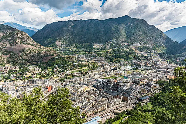 Andorra la Vella, City Center of the capital city of Andorra in between Pyrenees. View from above into the valley with surrounding Pyrenees Mountains, Andorra is a tiny independent principality situated between France and Spain in the Pyrenees mountains. It’s known for its ski resorts, and a tax-haven status that encourages duty-free shopping. Andorra, Europe.