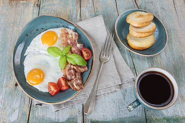 istock Fried eggs,  bacon, tomato, toast and a cup of coffee 508587954