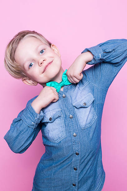 istock Young boy with blue shirt. Studio portrait over pink background 508588180