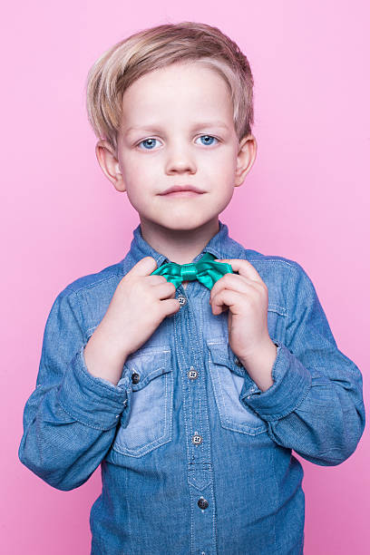 istock Young beautiful boy with blue shirt and butterfly tie 508588308