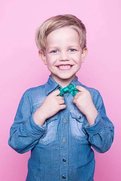 istock Young beautiful boy with blue shirt and butterfly tie 508588376