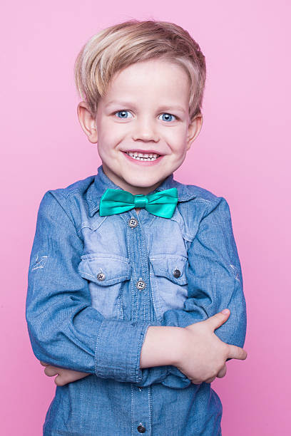 istock Young beautiful boy with blue shirt and butterfly tie 508588426