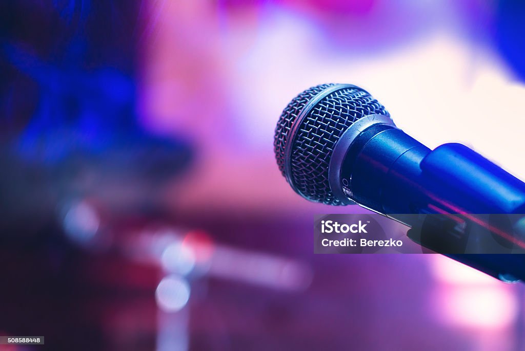 Microphone at concert Microphone on the stage on violet background. Microphone Stock Photo