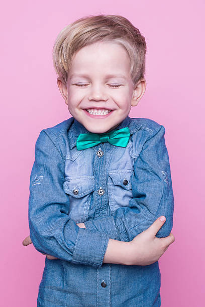 istock Young handsome kid smiling with blue shirt and butterfly tie 508588476