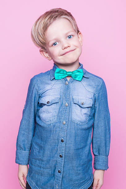 istock Young handsome kid smiling with blue shirt and butterfly tie 508588526