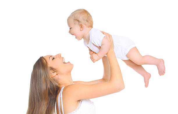 istock Happy smiling mother and baby playing on a white background 508589564