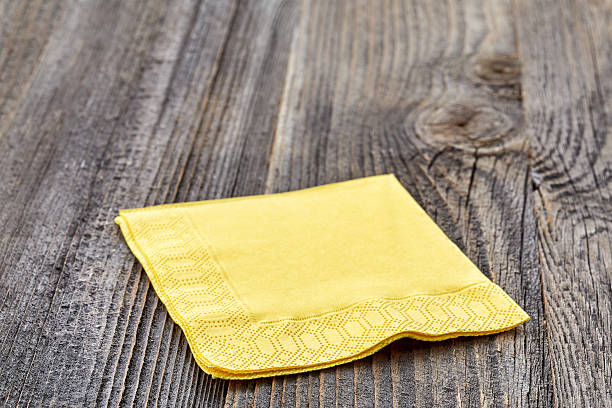 istock Yellow napkin on wooden table 508589566