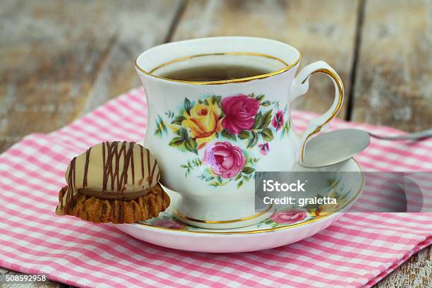 Tea In Colorful Vintage Porcelain Cup With Chocolate Toffee Cookie Stock Photo - Download Image Now