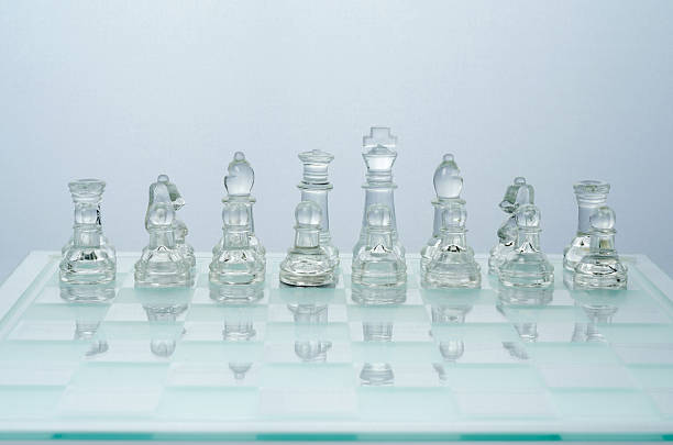 istock glass chess on the transparent chessboard 508593530