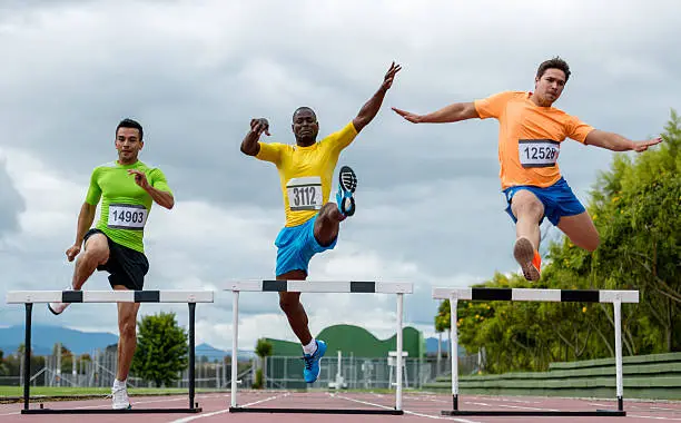 Competitive group of men steeplechasing - athletics concepts
