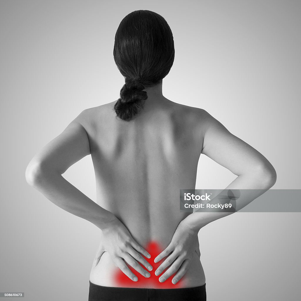 Backache Woman holding her lower back because of backache Backache Stock Photo