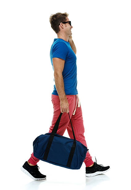 istock Smiling casual man talking on mobile & walking 508610785