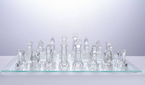 istock glass chess on the transparent chessboard 508618238