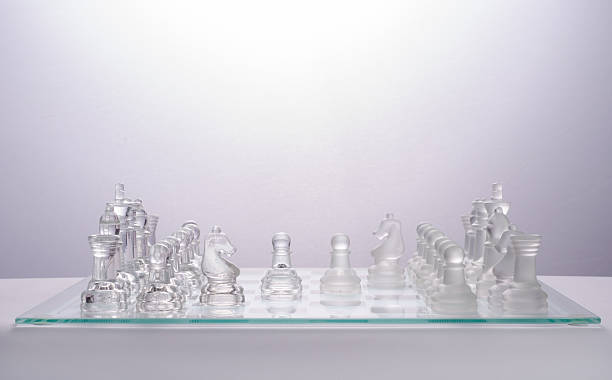 istock glass chess on the transparent chessboard 508618260