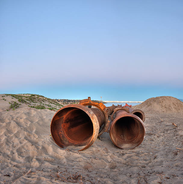 istock Dredge pipes lying side by side in the sand. 508618340