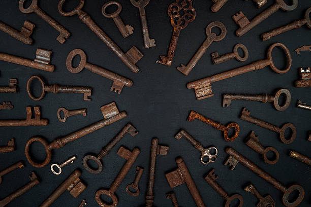 many keys on a blackboard with copy space many rusty keys on a blackboard with copy space in the middle. key strictly arranged. old key stock pictures, royalty-free photos & images