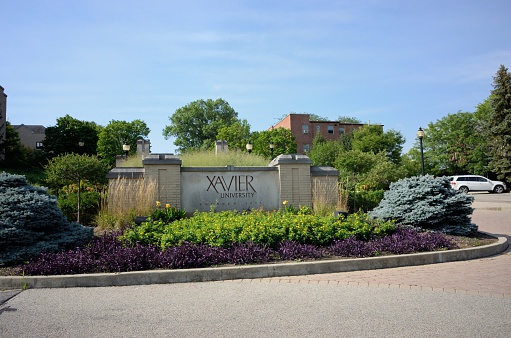 Cincinnati, Ohio, USA - August 9, 2015: Sign near the entrance to Xavier University Founded 1831. Sign located on the roundabout on Ledgewood Road in Cincinnati.